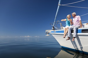 older man and woman sitting on boat